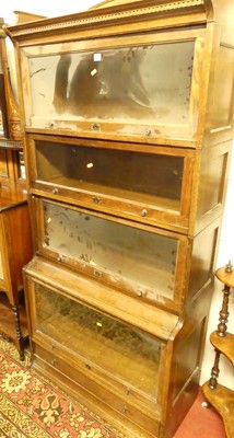 Lot 1148 - A 1930s oak Lebus four-tier stacking bookcase,...