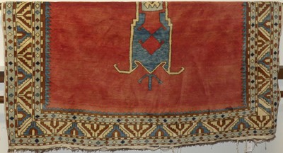 Lot 1171 - A Turkish woollen red ground rug, with...