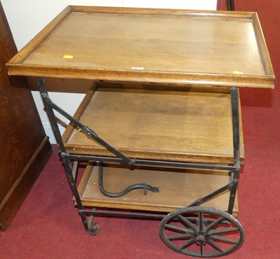 Lot 1184 - An early 20th century oak and iron three-tier...