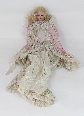 Lot 523 - A vintage bisque headed doll, having rolling...