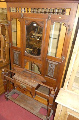 Lot 1196 - An Edwardian floral relief carved walnut...