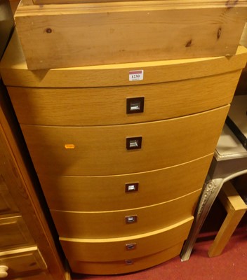 Lot 1230 - A contemporary blond oak bowfront chest of six...