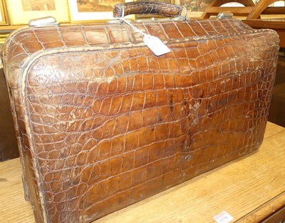 Lot 1237 - A 1920s crocodile skin travel bag, with metal...