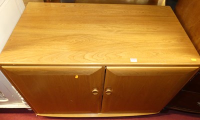 Lot 1243 - A contemporary Ercol blond elm double door...