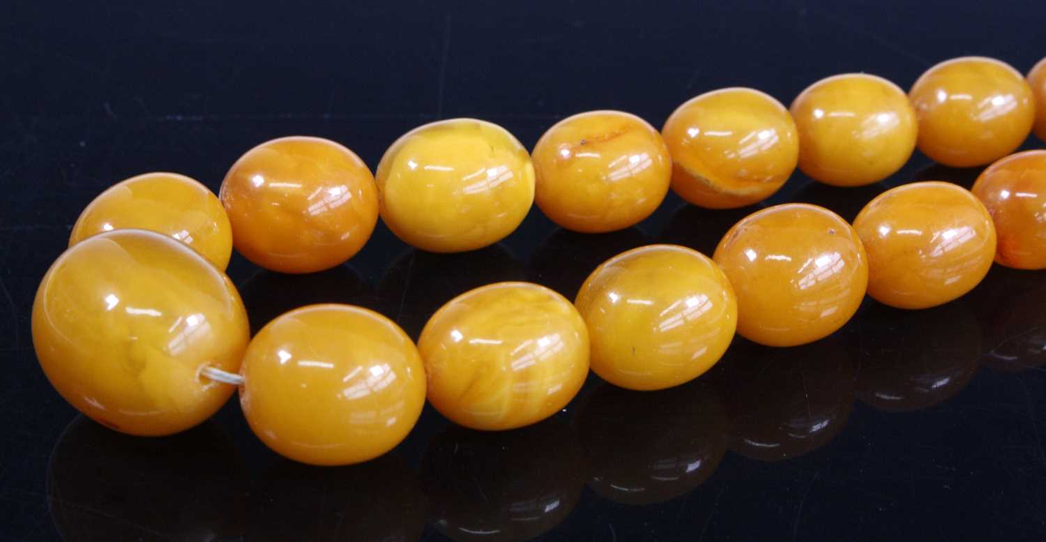 Lot 422 - A faux butterscotch amber necklace, arranged...