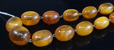 Lot 423 - A faux amber single string barrel bead...