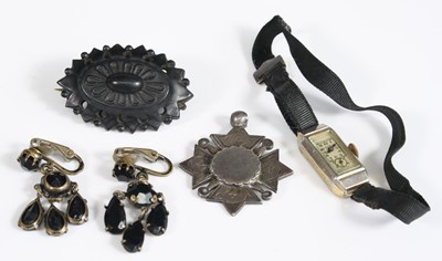 Lot 430 - A carved Whitby jet brooch; together with a...