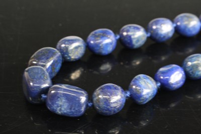 Lot 444 - A beaded lapis lazuli necklace, on single...