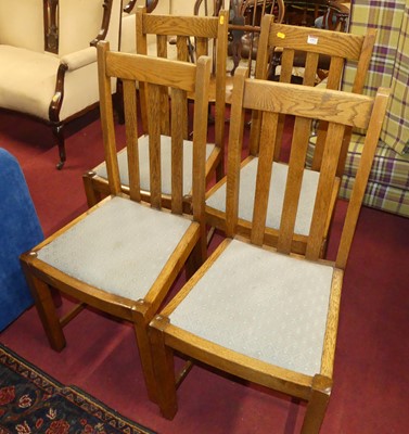 Lot 1353 - A set of four 1930s oak slatback dining chairs,...