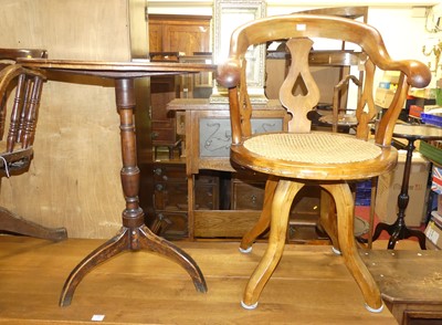 Lot 1379 - A hardwood tub revolving swivel desk chair,...