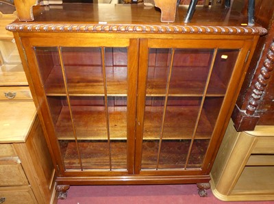 Lot 1402 - A 1930s mahogany double door glazed bookcase,...