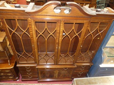 Lot 1406 - A contemporary mahogany breakfront bookcase,...