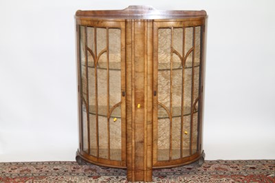 Lot 1422 - An Art Deco figured walnut ledge back...