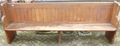 Lot 1442 - A late Victorian pitch pine long church pew,...