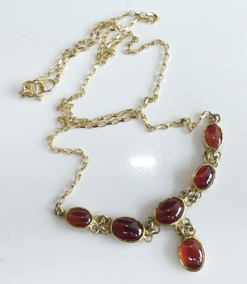 Lot 2503 - A yellow metal garnet multi-stone necklace,...