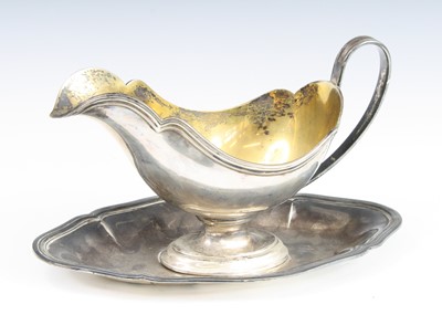 Lot 261 - An early 20th century German silver gravy boat...