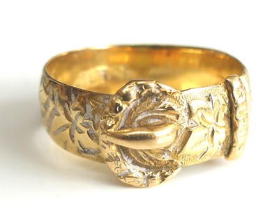 Lot 2505 - An 18ct yellow gold buckle ring engraved with...