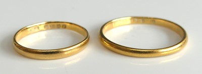 Lot 2509 - Two wedding bands, comprising a 22ct gold...