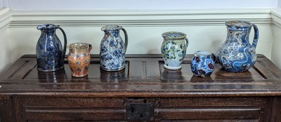 Lot 1018 - A collection of six studio pottery jugs, each...