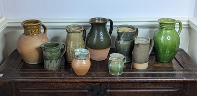 Lot 1017 - A collection of nine green and brown glazed...