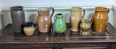 Lot 1020 - A collection of seven green & brown glazed...