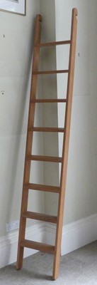 Lot 1281 - A contemporary blond oak eight tread library...