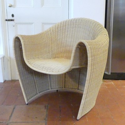 Lot 1320 - A woven wicker 'King Tubby' chair, of curved...