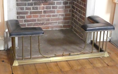 Lot 1335 - A brass breakfront club fender, having leather...