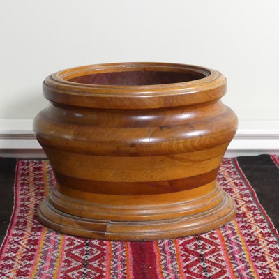 Lot 1078 - A turned and layered lignum vitae cylindrical...