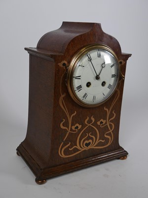 Lot 16 - An Art Nouveau oak cased mantel clock, having...