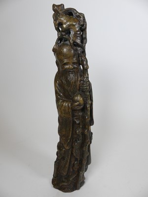 Lot 37 - A Chinese patinated bronzed metal figure of a...