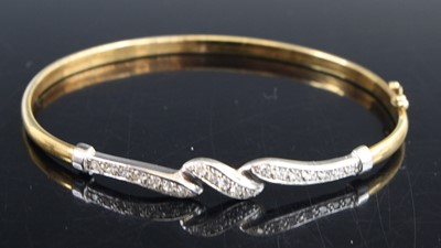 Lot 373 - A 9ct gold and CZ set hinge bangle as retailed...