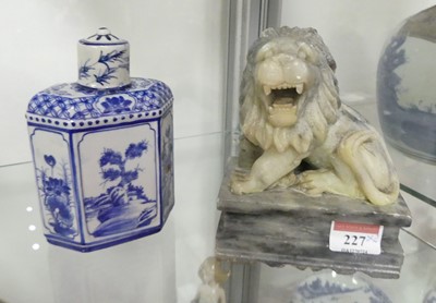 Lot 227 - A Chinese carved soapstone model of a lion,...