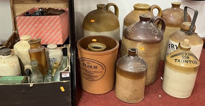 Lot 644 - A collection of stoneware jars and glass bottles