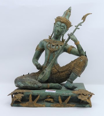 Lot 555 - A Thai gilt and verdigris metal figure of a...