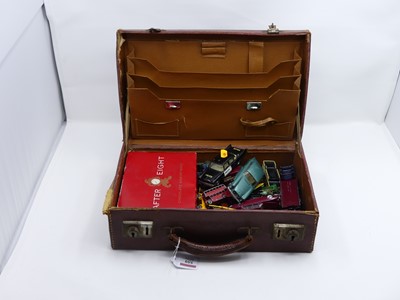 Lot 559 - A vintage tan leather suitcase, containing a...