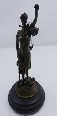 Lot 514 - A bronzed metal figure of Justice upon a black...