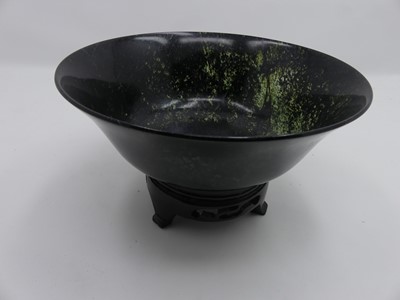 Lot 515 - A Chinese spinach jade bowl, dia.18cm, upon a...