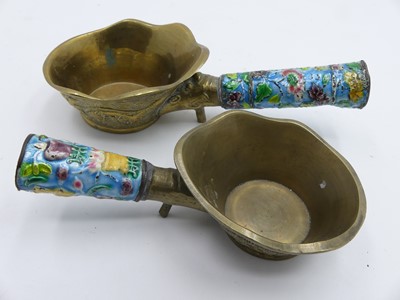 Lot 499 - A graduated pair of Chinese brass ladles, each...