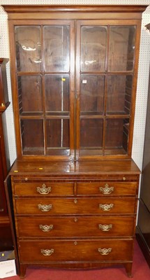 Lot 1150 - A 19th century mahogany bookcase-on-chest, the...