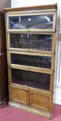 Lot 1183 - A 1930s oak five-tier stacking bookcase, the...