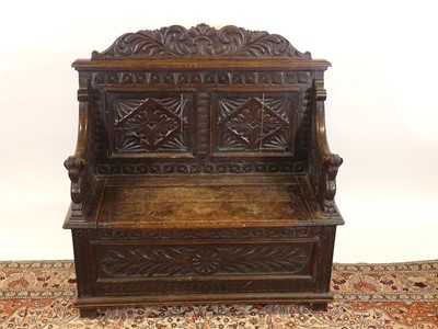 Lot 1204 - A circa 1900 heavily relief carved oak twin...