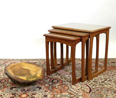 Lot 1331 - A 1970s teak nest of three occasional tables,...