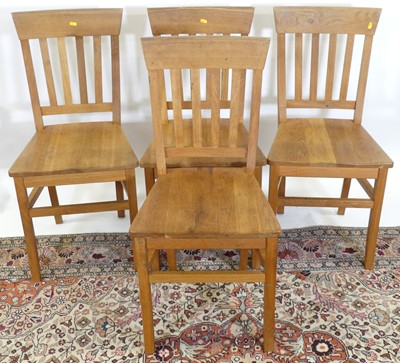 Lot 1300 - A set of four contemporary honey oak slat back...