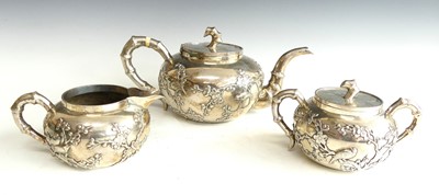 Lot 2448 - A circa 1900 Chinese silver three-piece tea...