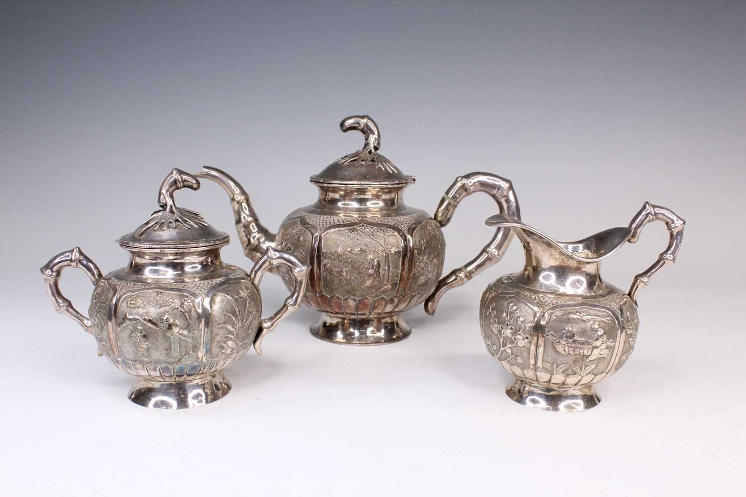 Lot 2066 - A Chinese export silver three-piece tea set,...