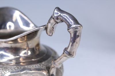 Lot 2066 - A Chinese export silver three-piece tea set,...