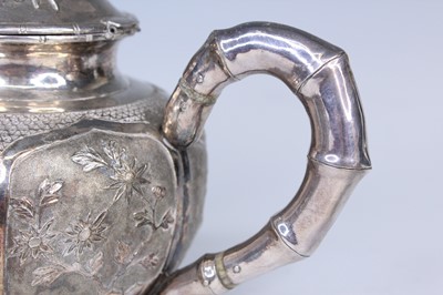 Lot 2066 - A Chinese export silver three-piece tea set,...