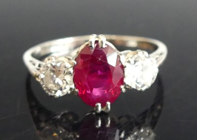 Lot 2324 - A white metal, ruby and diamond three-stone...