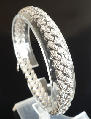 Lot 2326 - A 9ct white gold diamond line bracelet, having...